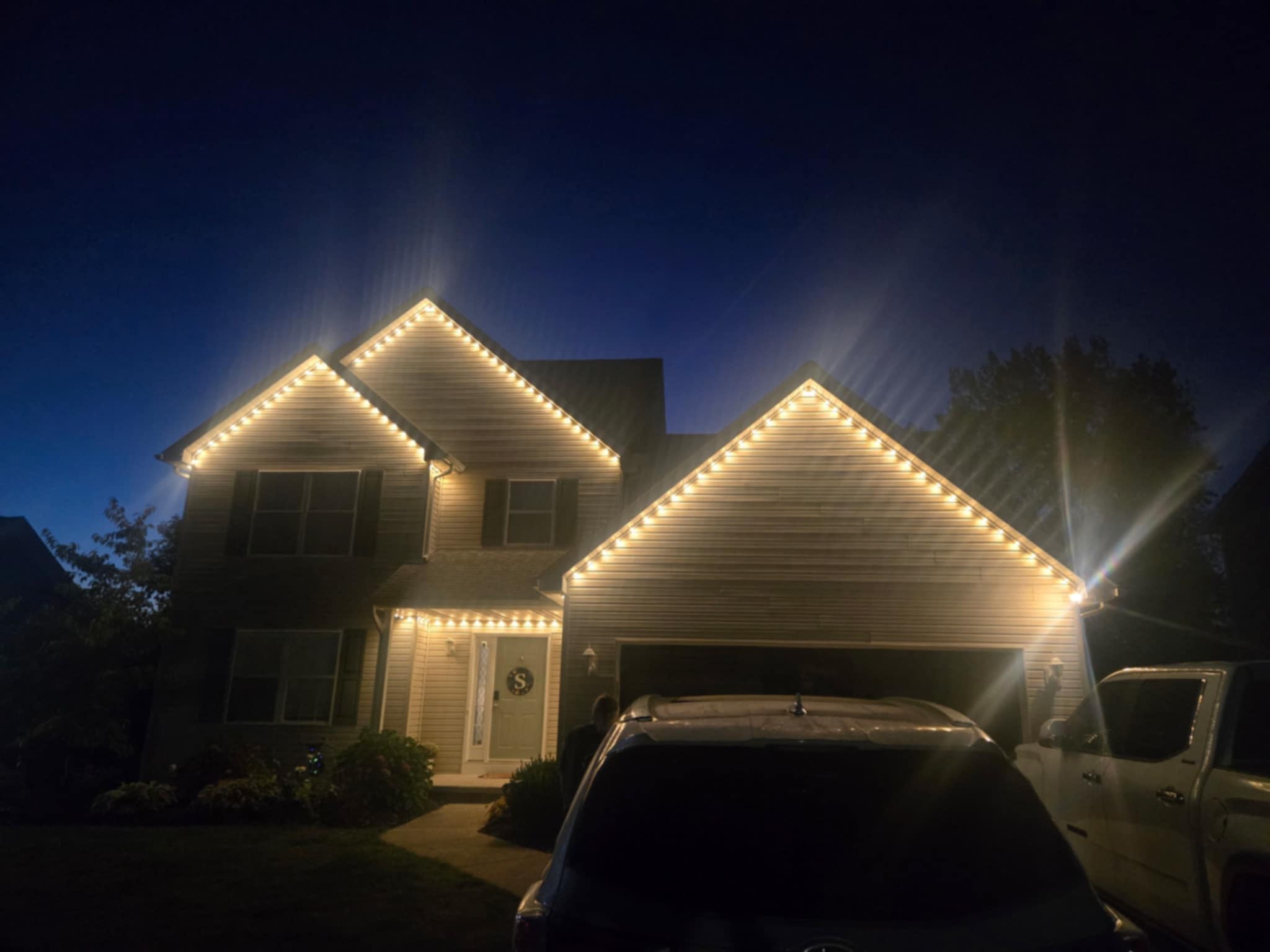 Home with warm white permanent roofline lighting