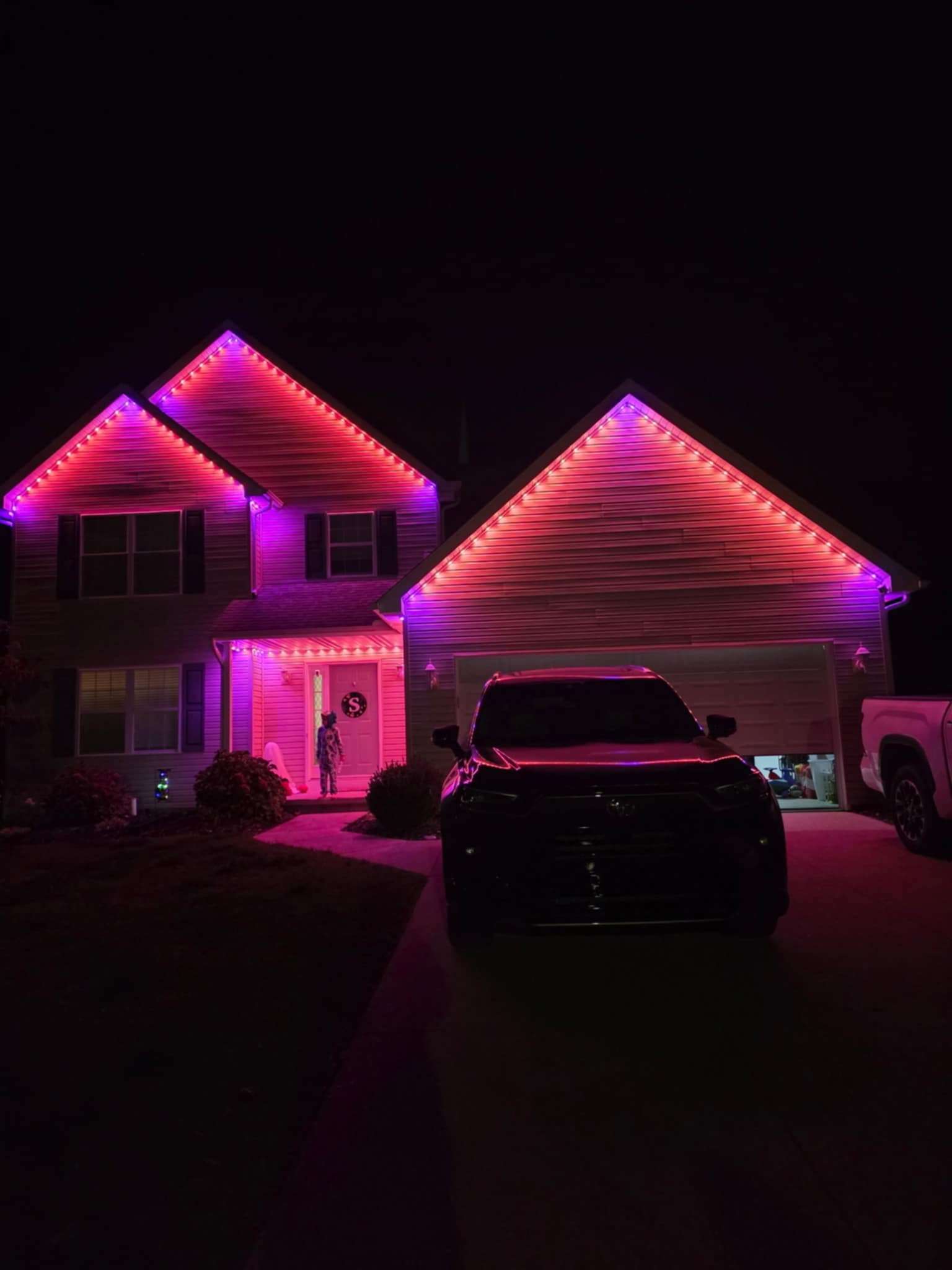 Home lit in vibrant color with permanent lighting